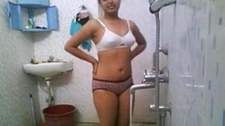 Indian college student Nikita takes a bath in a public bathroom