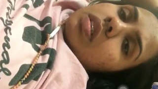 A charming college student flaunting her breasts in a video call