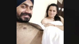 Indian couple in hotel room with audio