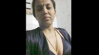 Hot Desi bhabhi in a black bra and panties in the bathroom