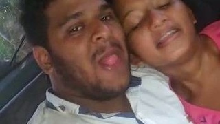 Real sex video of a young couple in a car having oral sex and kissing