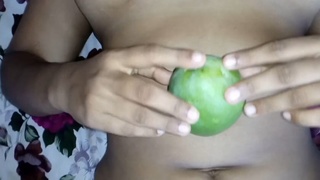 Indian girl puts mango inside her pussy