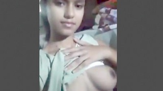 A young Indian girl pleasures herself with her big tits and pussy on camera