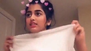 Watch a hot Indian teen strip and show off her nude body in a sexy video