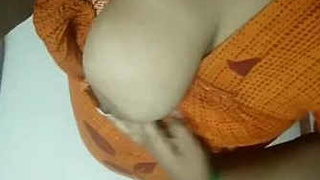 Tamil girl fondles her own breasts in a seductive manner
