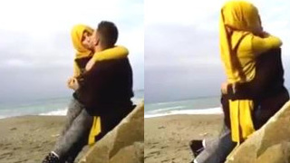 Muslim couple kiss passionately in hijab