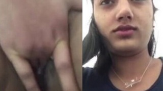 Young girl pleasures herself with her fingers