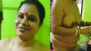Fat Indian village woman with large breasts undresses and gets naked