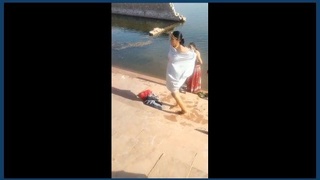 Indian women take a bath together in a village setting